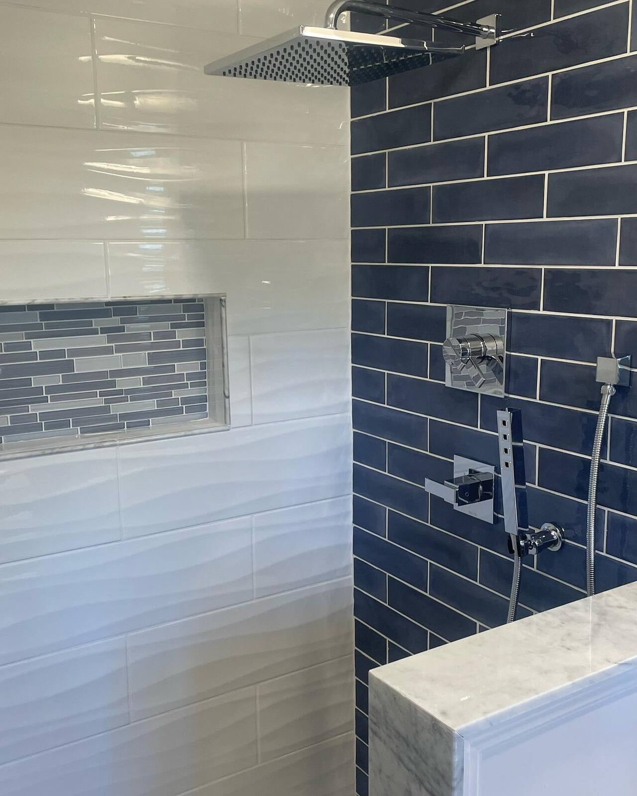 Blue, White, and mixed Glass Tile Shower.