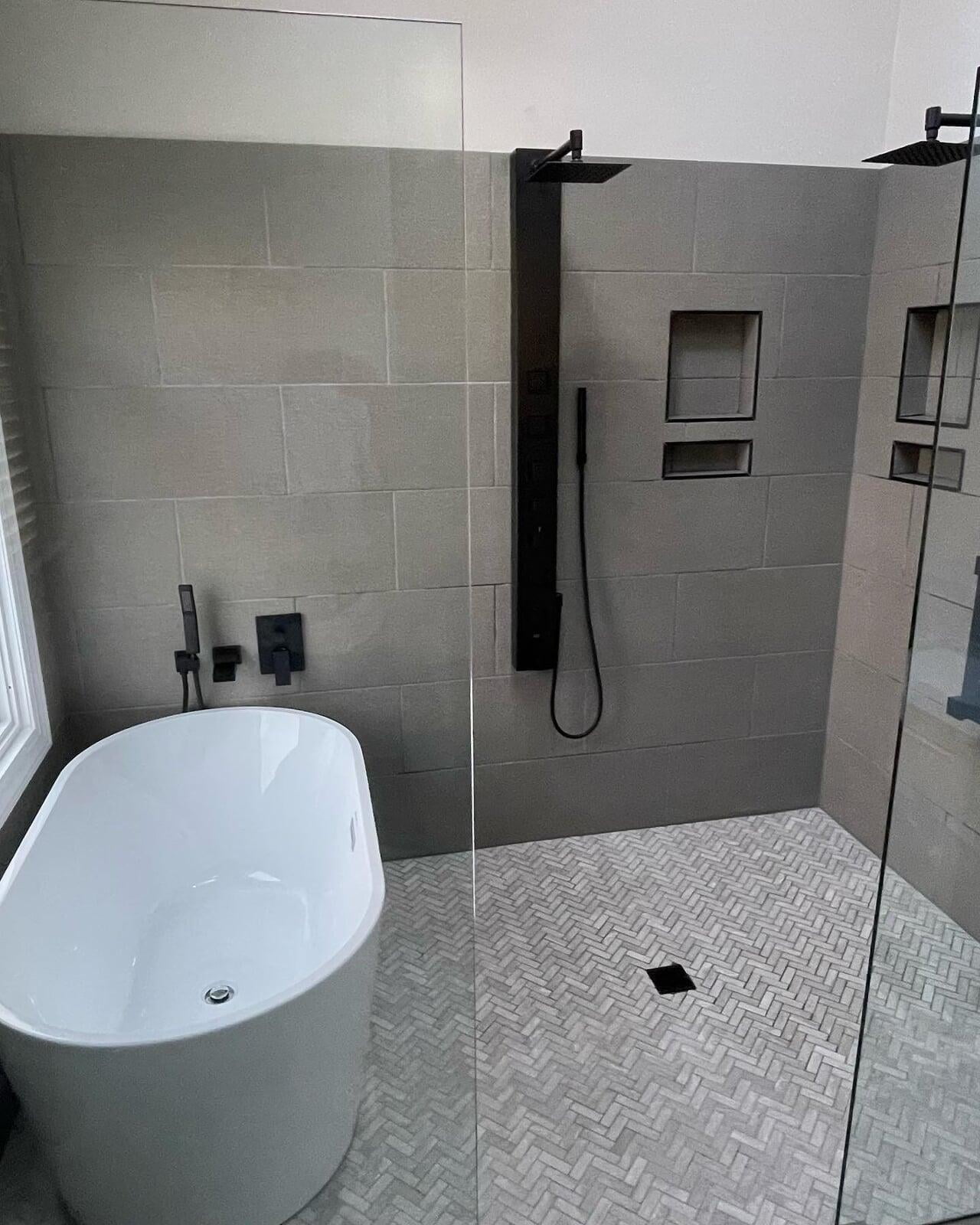 Bathroom Remodel. Tile, oval tub, glass shower surround.