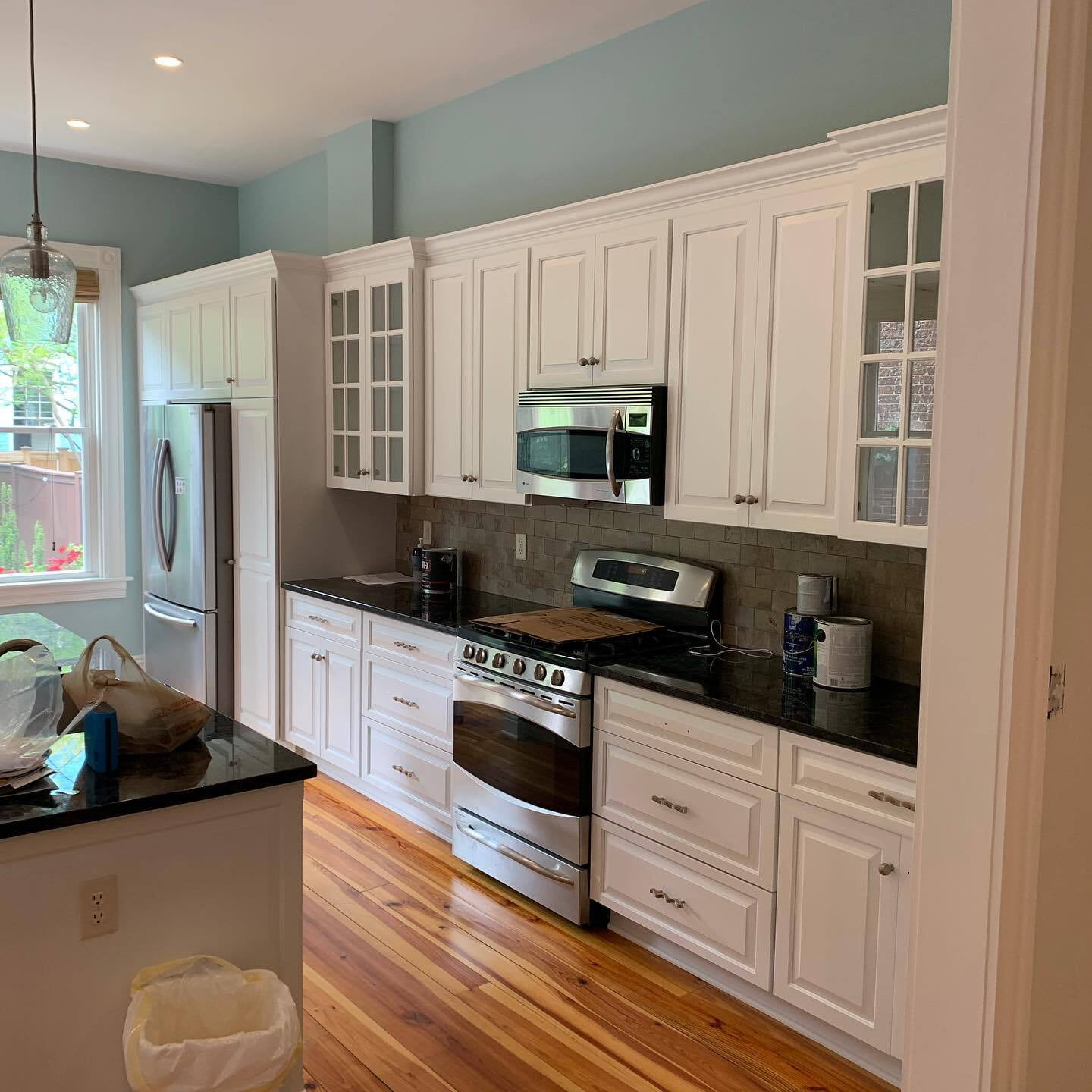 Cream colored top cabinets and white bottom cabinets.