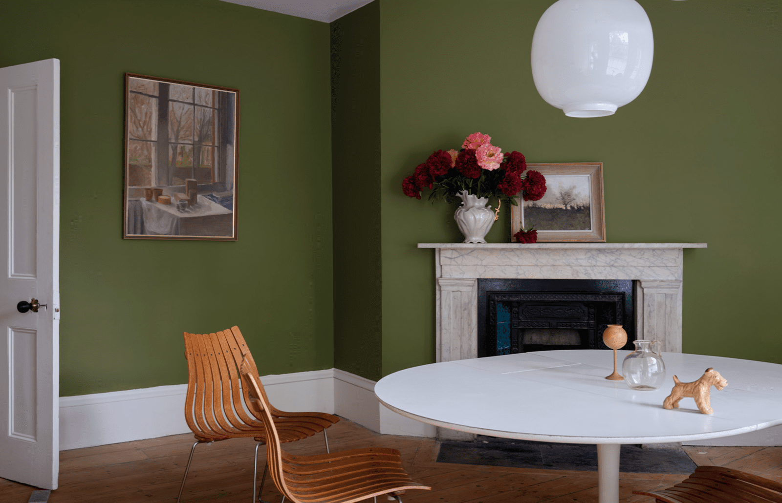 Interior house painting. Wall painted green with white trim.