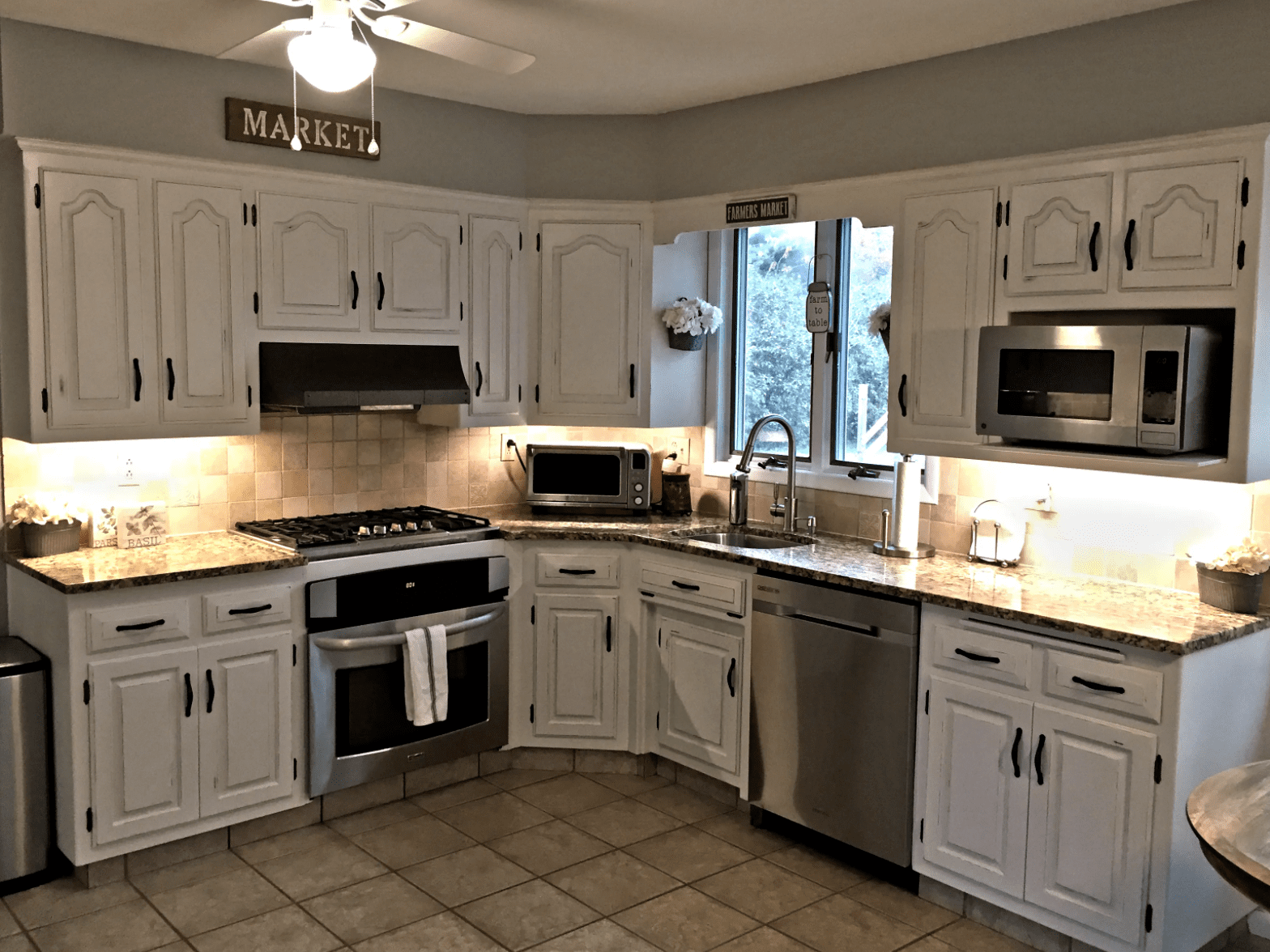 Refinished white cabinets top and bottom.